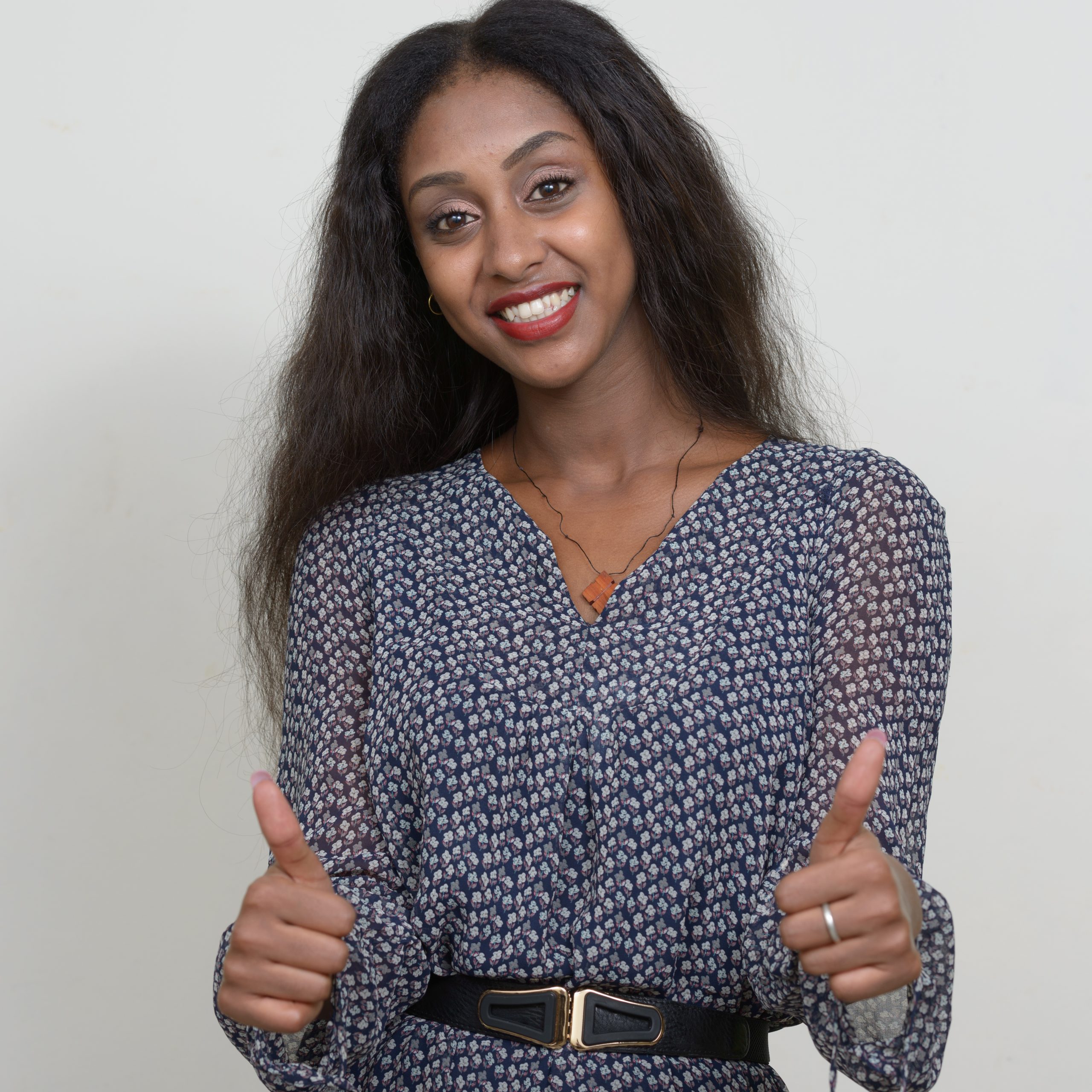 Studio shot of young beautiful African woman against white background